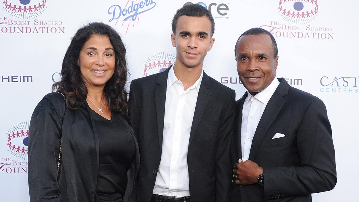 Sugar Ray Leonard with Bernadette Robi and son Daniel Ray Leonard arriving at an event