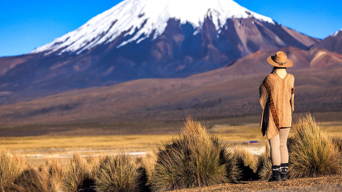 Woman standing near volcano in Bolivia
