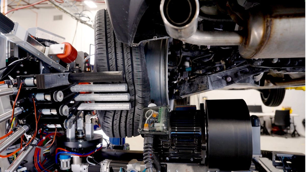 A robotic system changes a tire.