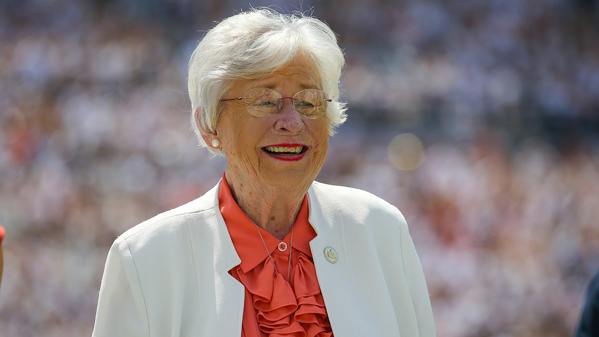 Alabama Gov. Kay Ivey standing on football field during halftime at Jordan-Hare Stadium