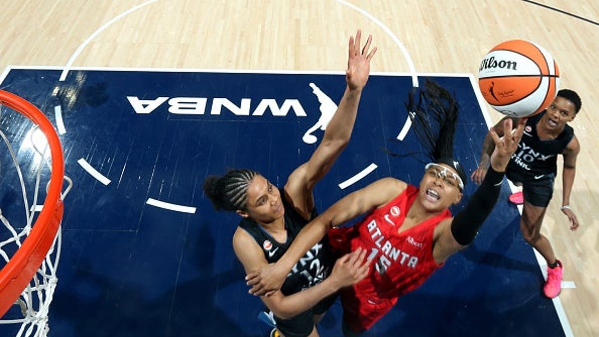 Allisha Gray of the Atlanta Dream drives to the basket during a basketball game.