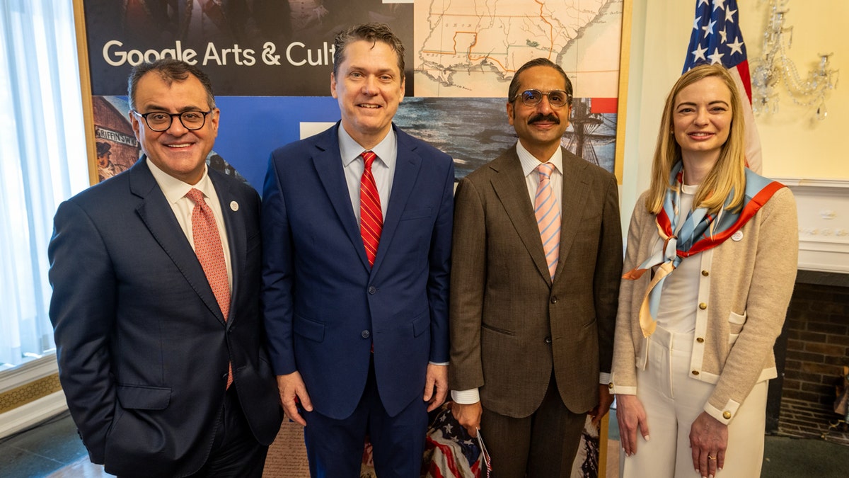 Karan Bhatia and Vince Haley seated with Amit Sood and Brittany Baldwin at a meeting
