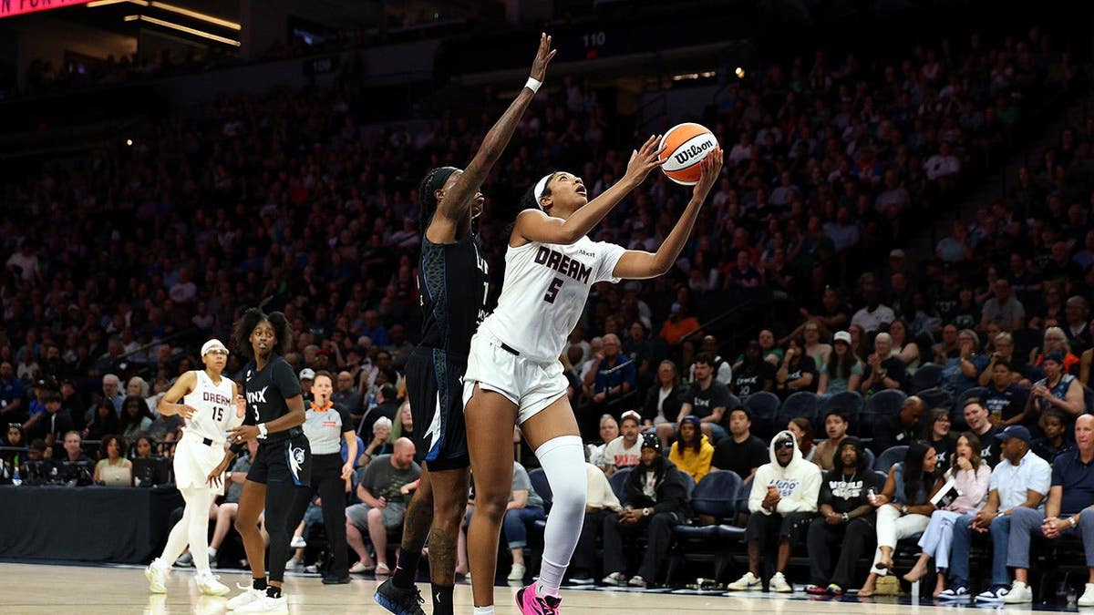 Angel Reese of the Atlanta Dream shooting against Natasha Howard of the Minnesota Lynx at Target Center