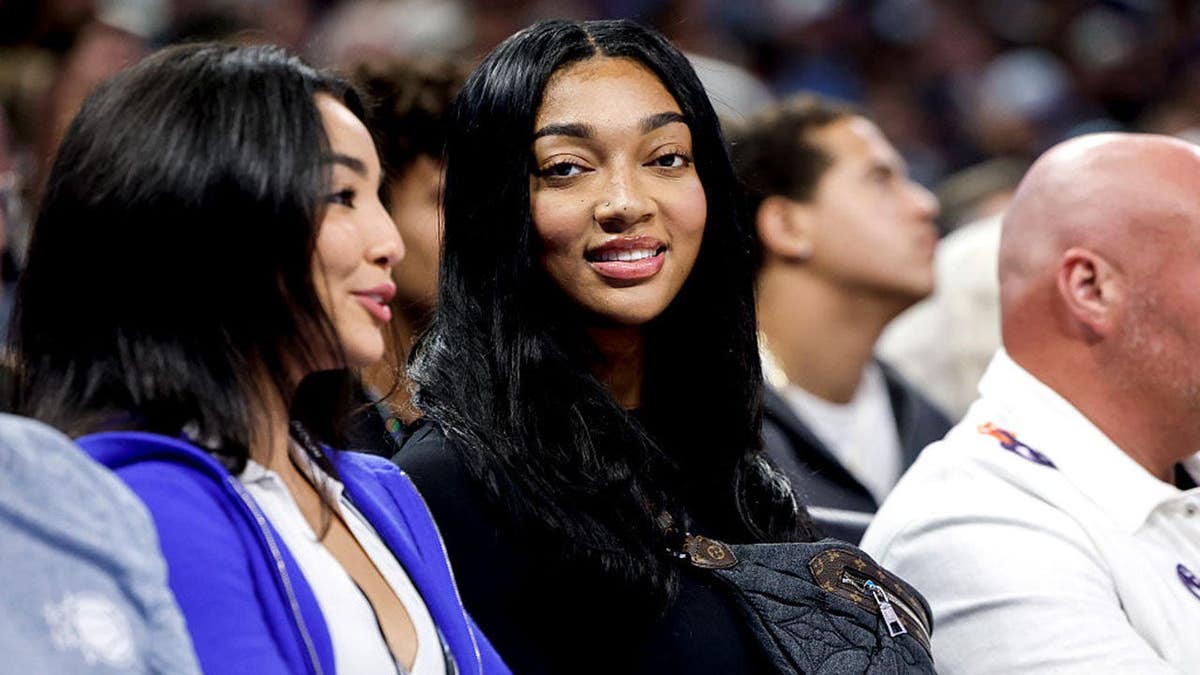 Angel Reese of the Chicago Sky sitting courtside at the Kia Center