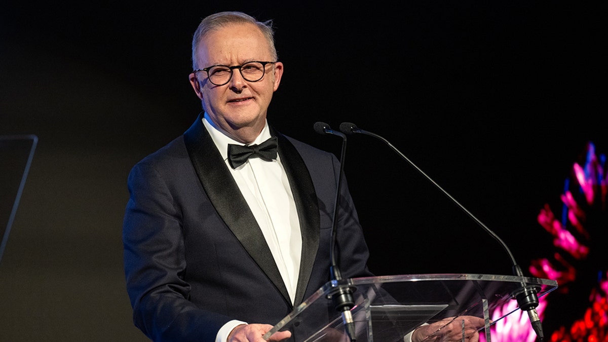 Australian Prime Minister Anthony Albanese in formal attire on the stage for the MCRI gala.