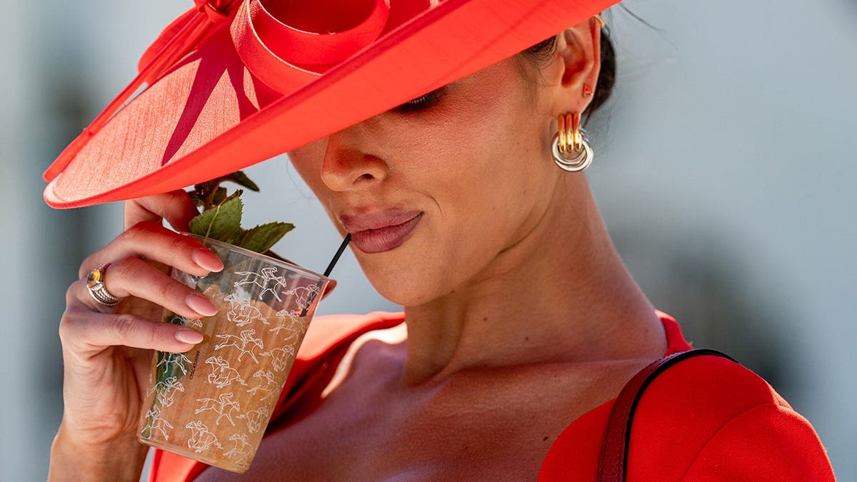 Ashlyn Roberts enjoying a mint julep at Churchill Downs in Louisville, Ky.
