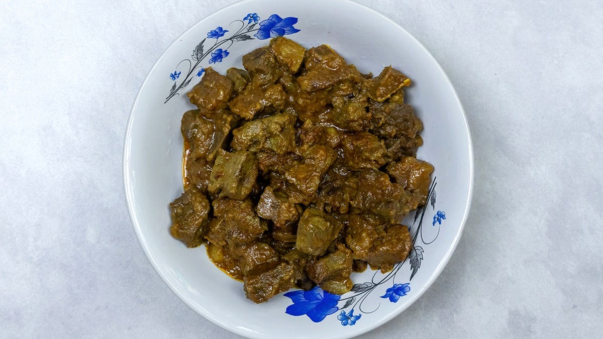 Grilled beef liver Kolija Bhuna is served in a white bowl