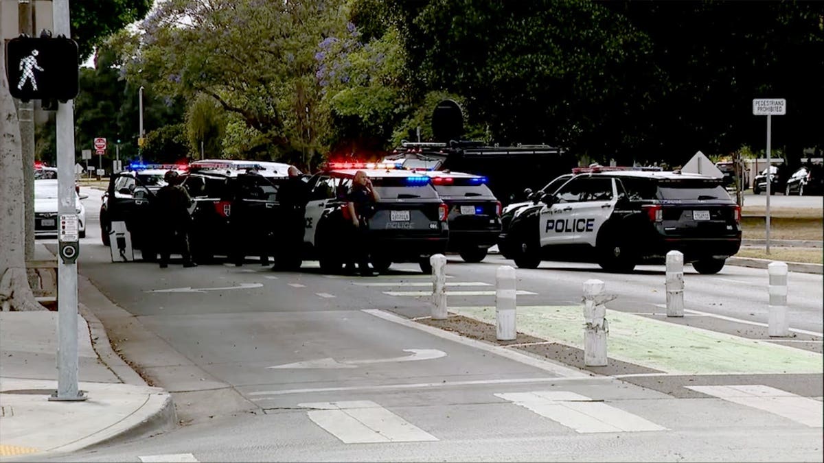 Authorities surrounding a vehicle during a standoff in Beverly Hills
