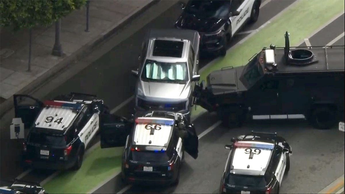 Authorities surrounding a vehicle during a standoff in Beverly Hills