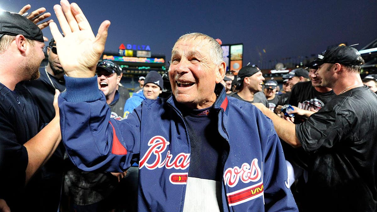 Atlanta Braves manager   Bobby Cox celebrating with his squad  connected  the field
