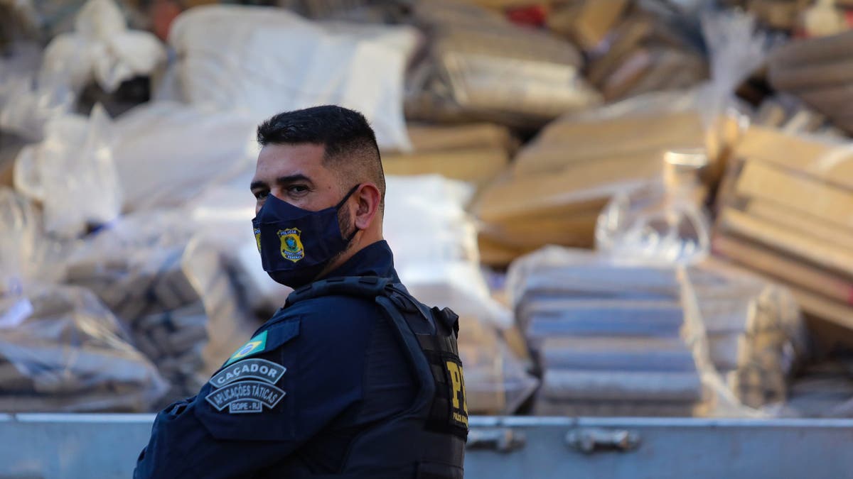 Police officers watch over 20 tons of drugs being incinerated in ovens at Companhia Siderurgica Nacional in Volta Redonda Brazil