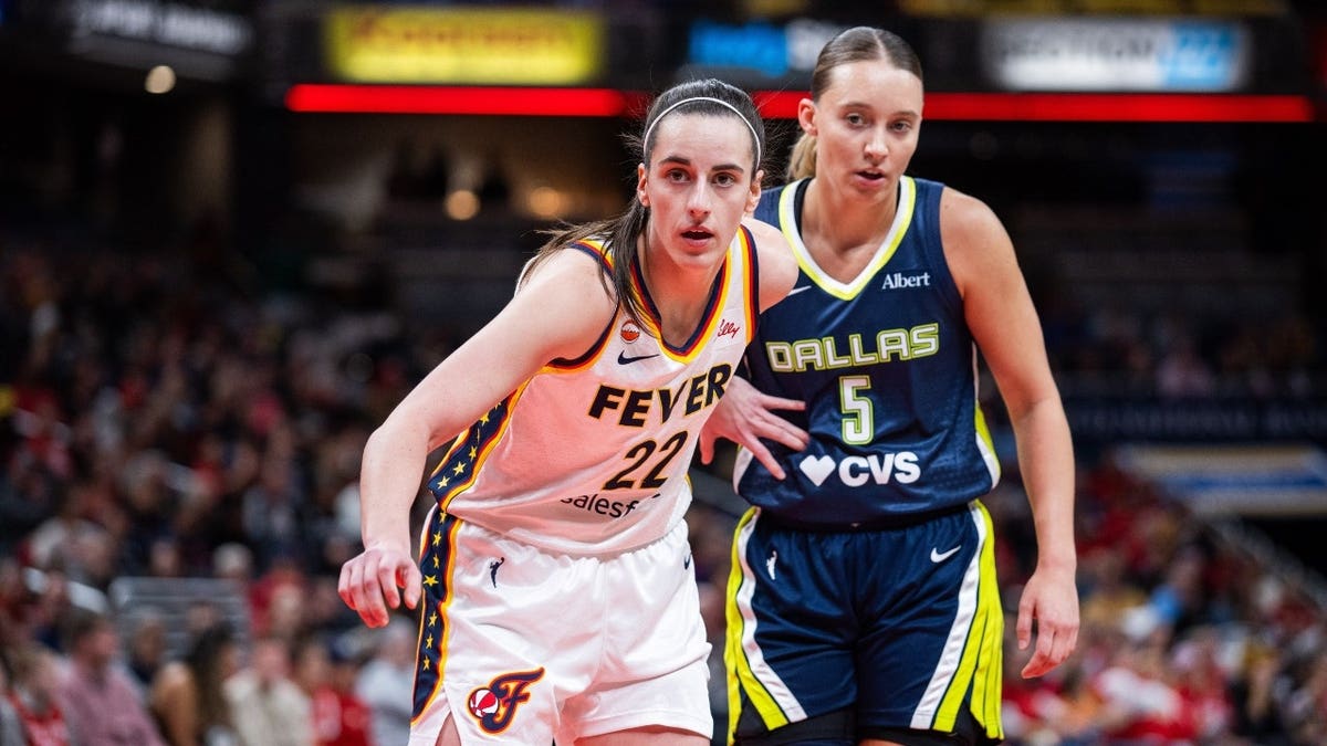 Dallas Wings defender  Paige Bueckers defends Indiana Fever defender  Caitlin Clark during an inbounds play   successful  a WNBA crippled  astatine  Gainbridge Fieldhouse successful  Indianapolis.