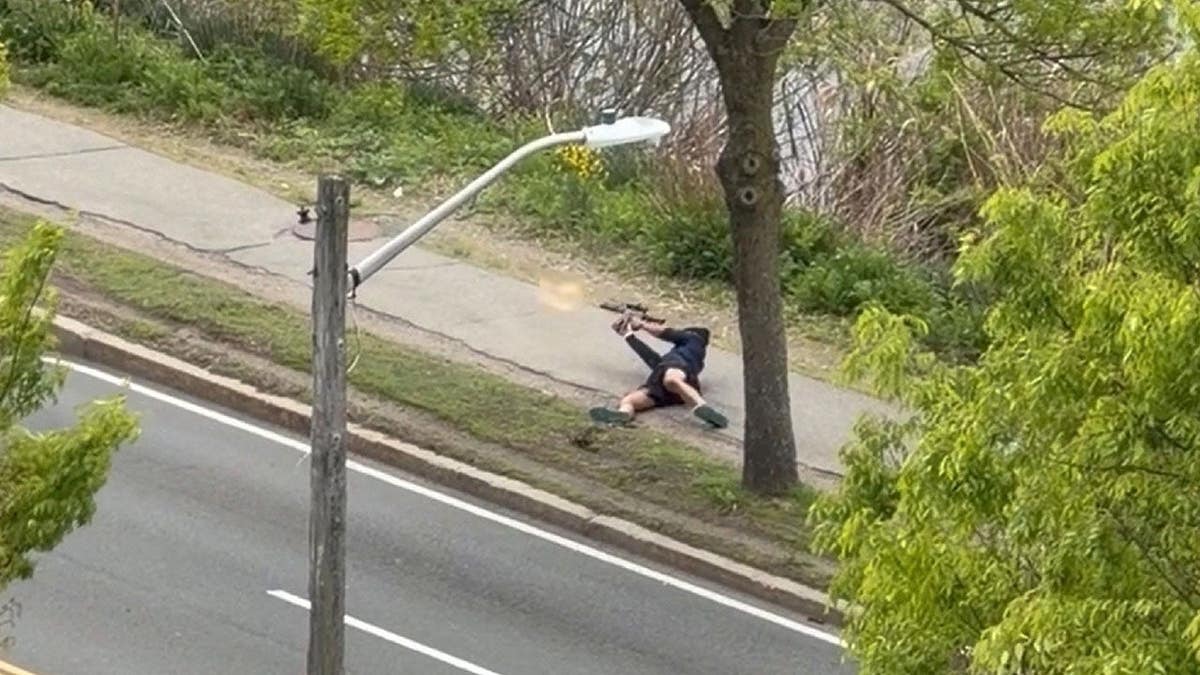 A man firing an assault-style rifle at a busy road in Cambridge, Mass.