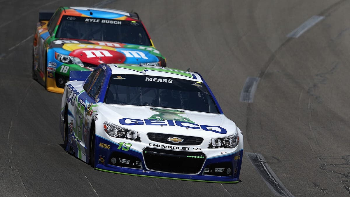 Casey Mears driving the #13 GEICO Chevrolet leads Kyle Busch driving the #18 M&M's Toyota connected a racetrack