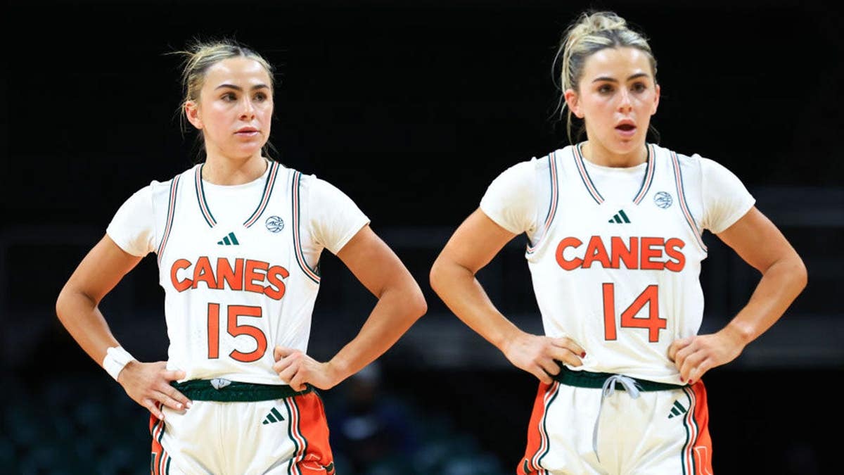 Hanna Cavinder and Haley Cavinder watching basketball game at Watsco Center