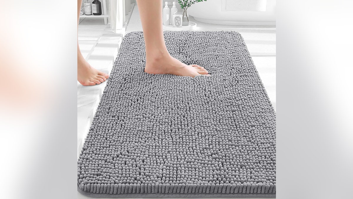 Feel more comfortable stepping out of the shower with this absorbent bath rug.
