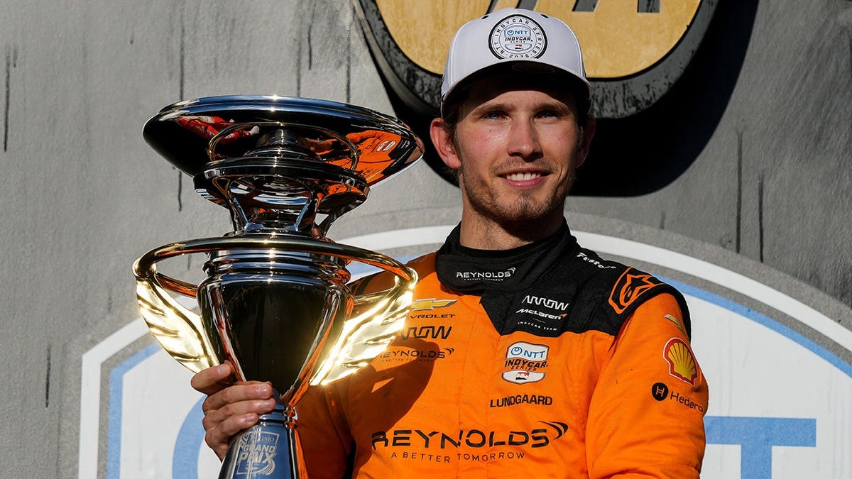 Christian Lundgaard posing with his contention    suit   aft  winning the Sonsio Grand Prix