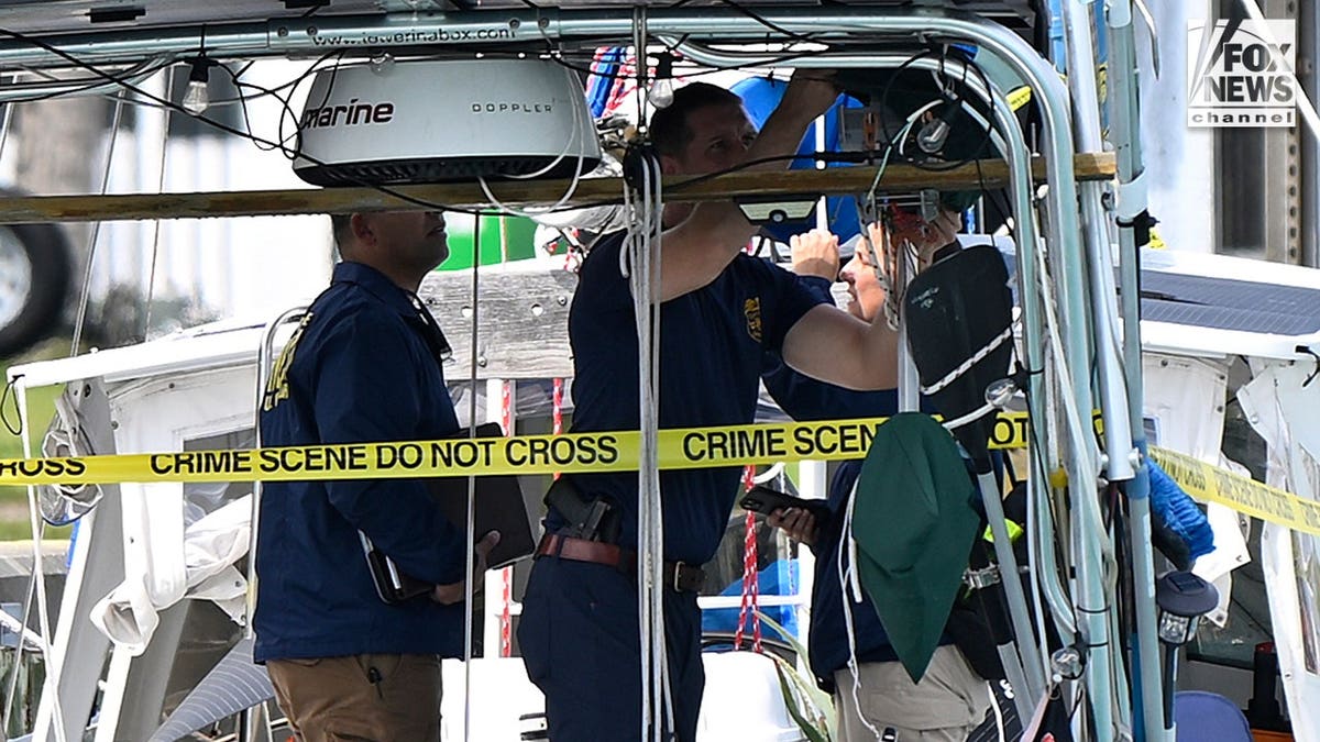 U.S. Coast Guard investigators search Brian Hooker's and his missing wife Lynette Hooker's the boat Soulmate.