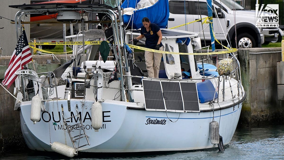 U.S. Coast Guard investigators search Brian Hooker's and his missing wife Lynette Hooker's the boat Soulmate.