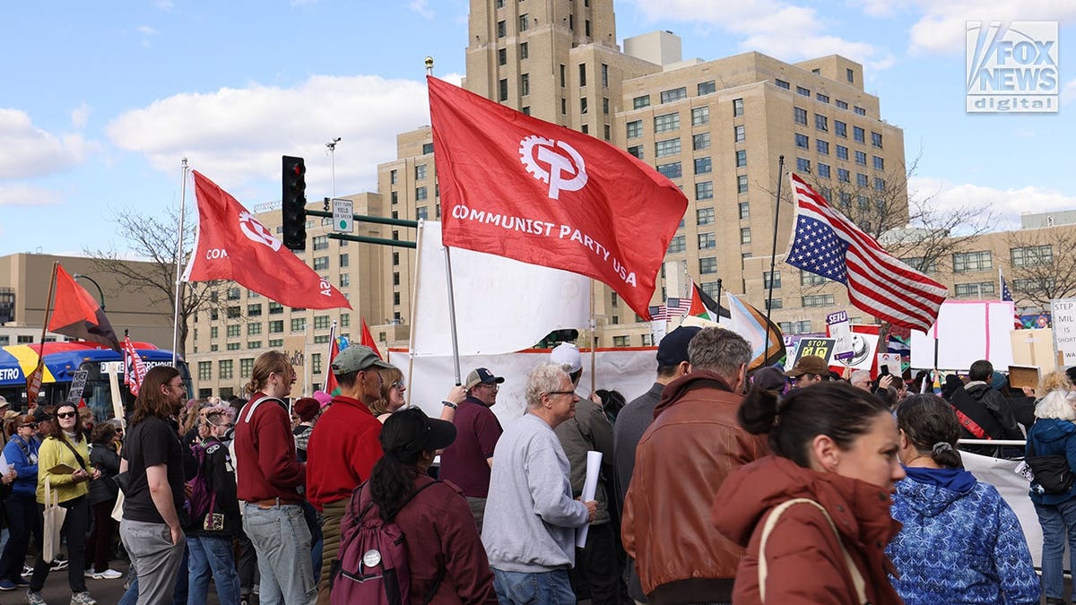 Communist Party USA flags held by protesters at Minneapolis May Day rally