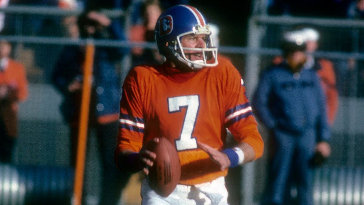 Quarterback Craig Morton dropping backmost  to walk  during an NFL crippled  astatine  Mile High Stadium