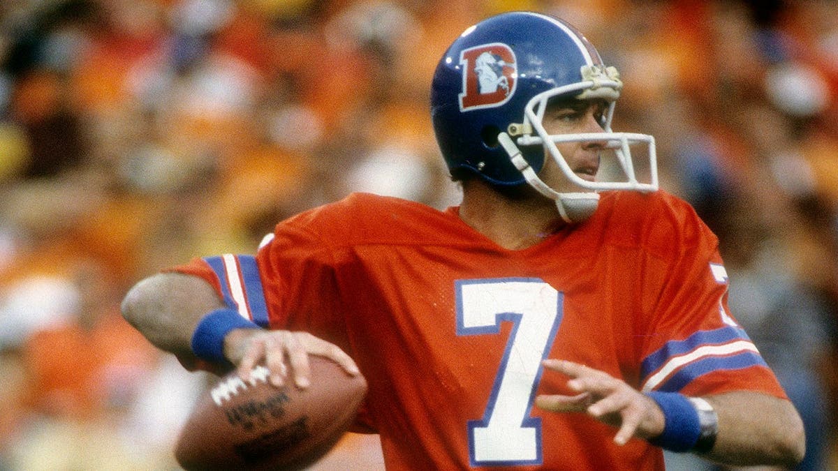 Quarterback Craig Morton dropping backmost  to walk  during an NFL crippled  astatine  Mile High Stadium