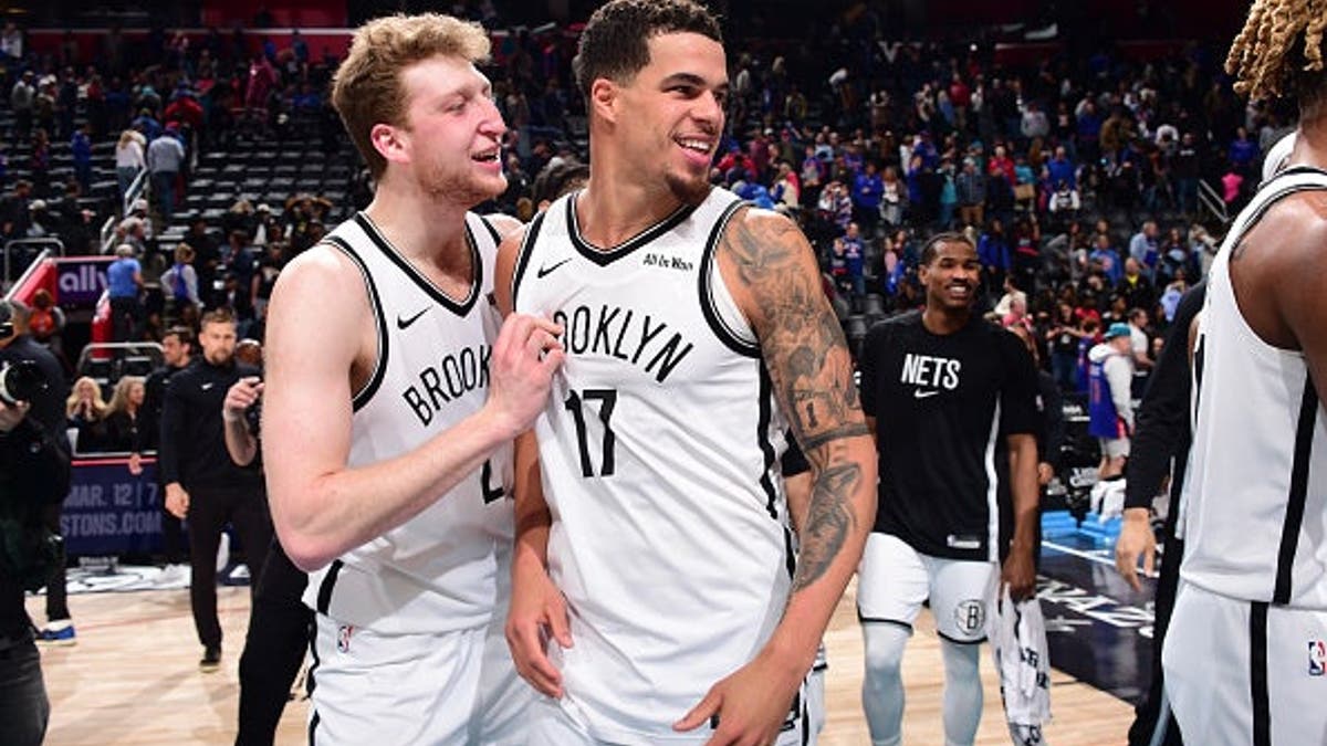 Danny Wolf and Michael Porter Jr. celebrating on basketball court