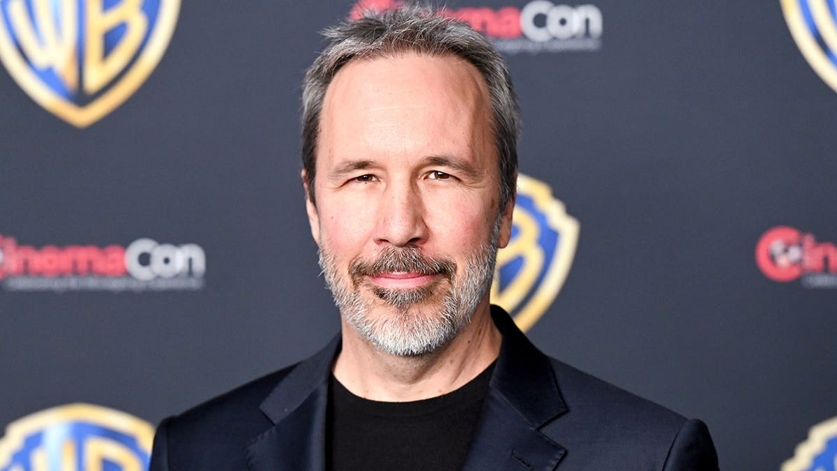 Denis Villeneuve standing at the Warner Bros. Pictures Photocall at CinemaCon in Las Vegas