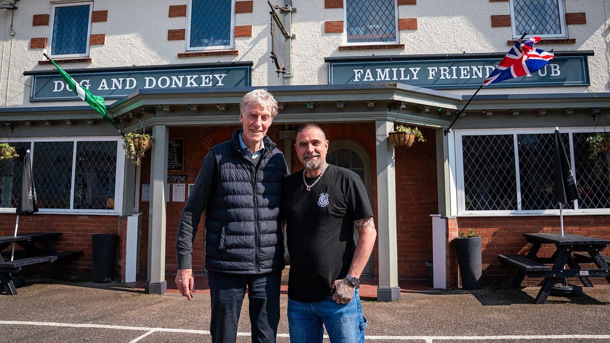 Pete Manfield and landlord Mark Loftin standing inside The Dog and Donkey pub in Knowle, Devon