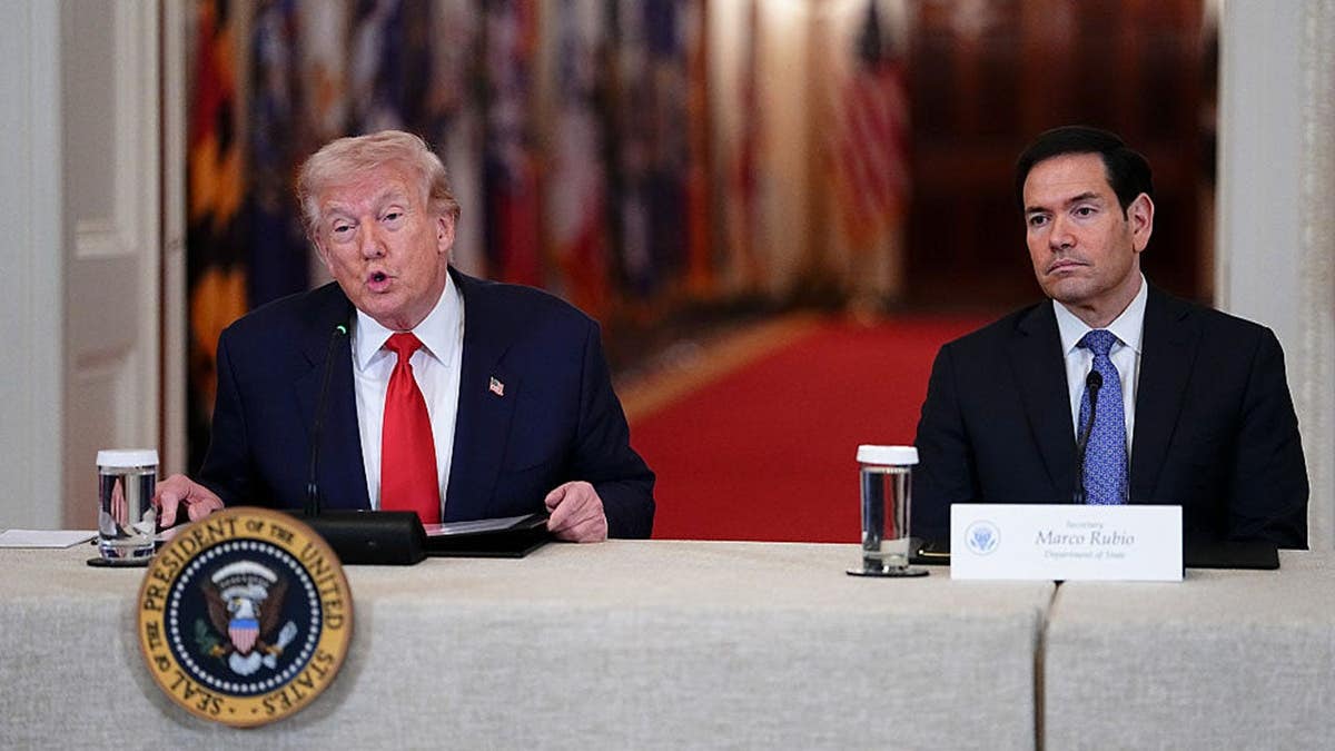 President Donald Trump and Secretary of State Marco Rubio seated during a roundtable successful  the White House East Room