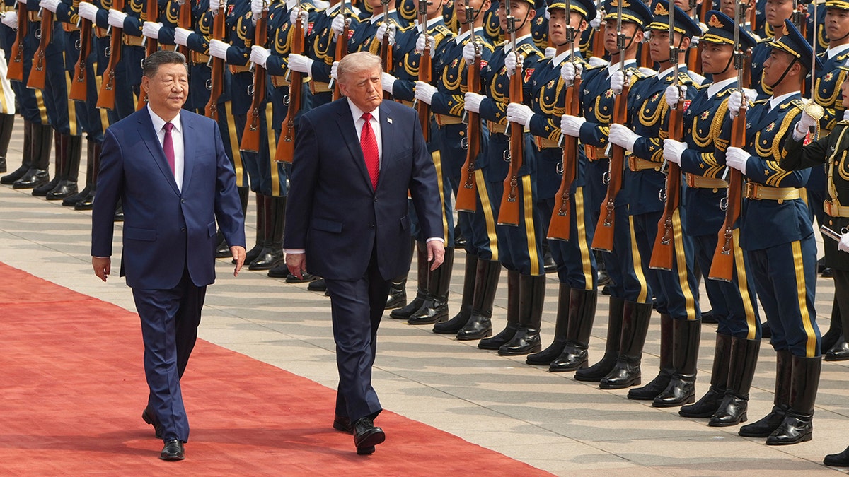 Donald Trump walks alongside Xi Jinping during a welcome ceremony at the Great Hall of the People.