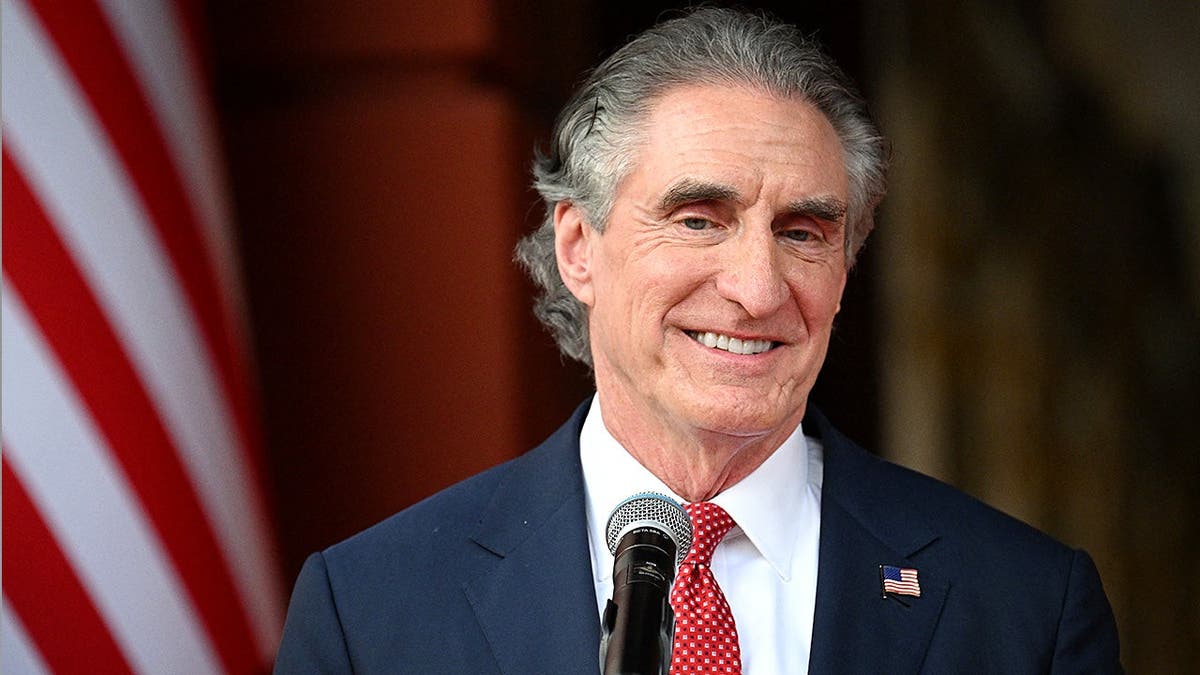 Doug Burgum reacts during meeting at Venezuelan presidential palace.