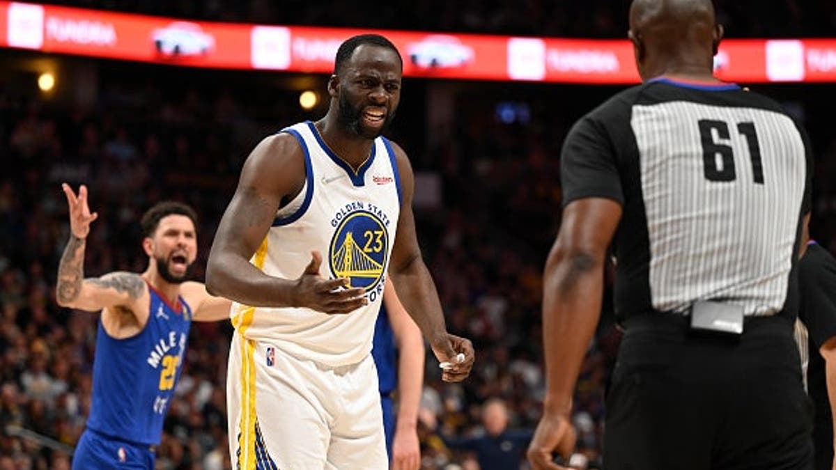 Draymond Green and Austin Rivers disputing a call with referee Courtney Kirkland on basketball court