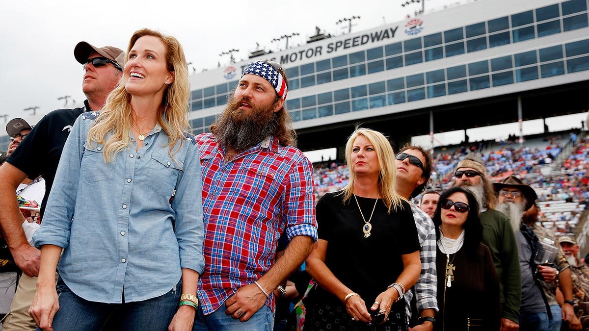 Korie Robertson, Willie Robertson, Lisa Robertson, Alan Robertson, Kay Robertson, Phil Robertson and Si Robertson standing at Texas Motor Speedway