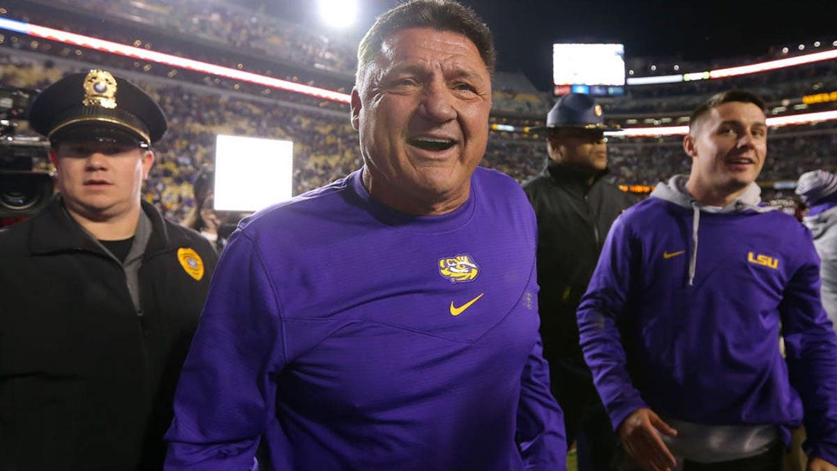 Head coach Ed Orgeron celebrating on the field at Tiger Stadium
