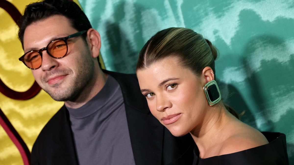 Elliot Grainge and Sofia Richie Grainge posing at the Warner Music Group Pre-GRAMMY Party in Los Angeles