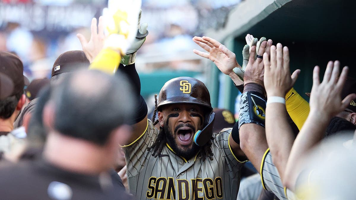 Fernando Tatis Jr. celebrando con sus compañeros de equipo durante un partido de béisbol.