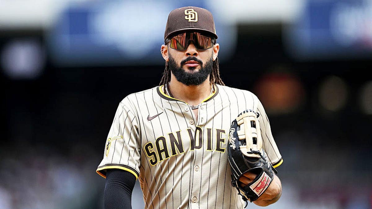 Fernando Tatis Jr. running in from the outfield during a baseball game.