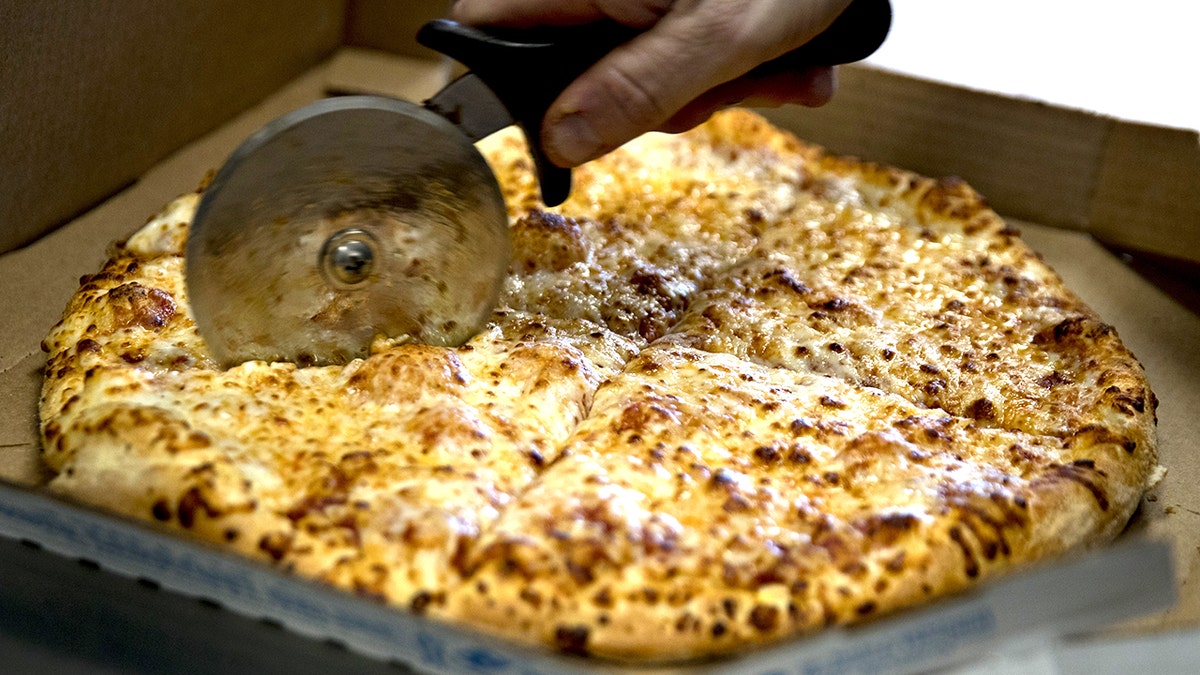 Employee slicing Domino's pizza