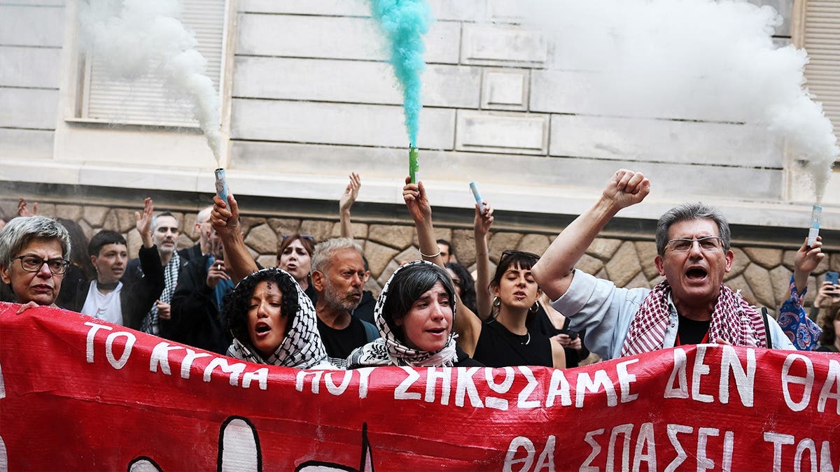 Pro-Palestinian protesters wave flags and hold smoke flares during a demonstration in Athens over Israel’s interception of the Global Sumud flotilla.