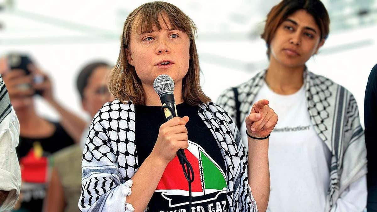 Climate activist Greta Thunberg speaking at a pro-Palestinian event in Italy while wearing a keffiyeh scarf.