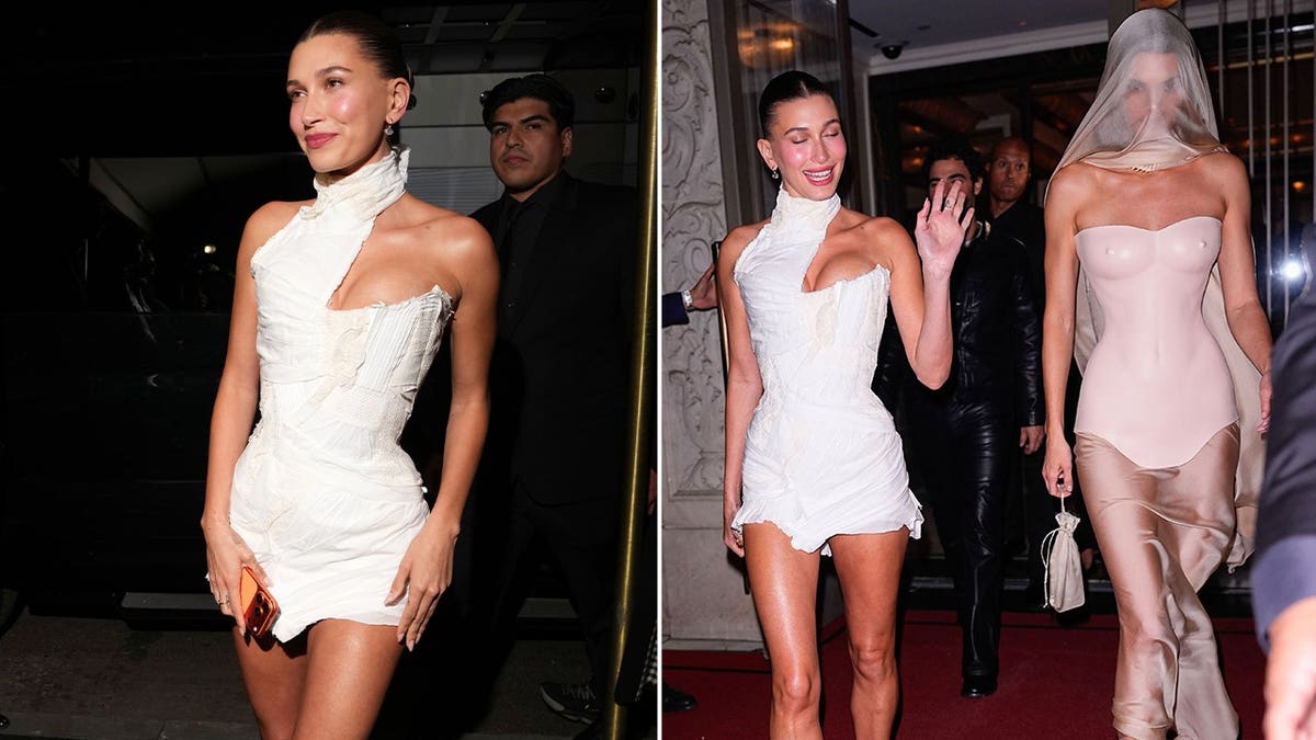 Hailey Bieber and Kendall Jenner leaving an event at night; one in a short white asymmetrical mini dress smiling and waving, the other in a nude-toned outfit with a sheer veil covering her face.