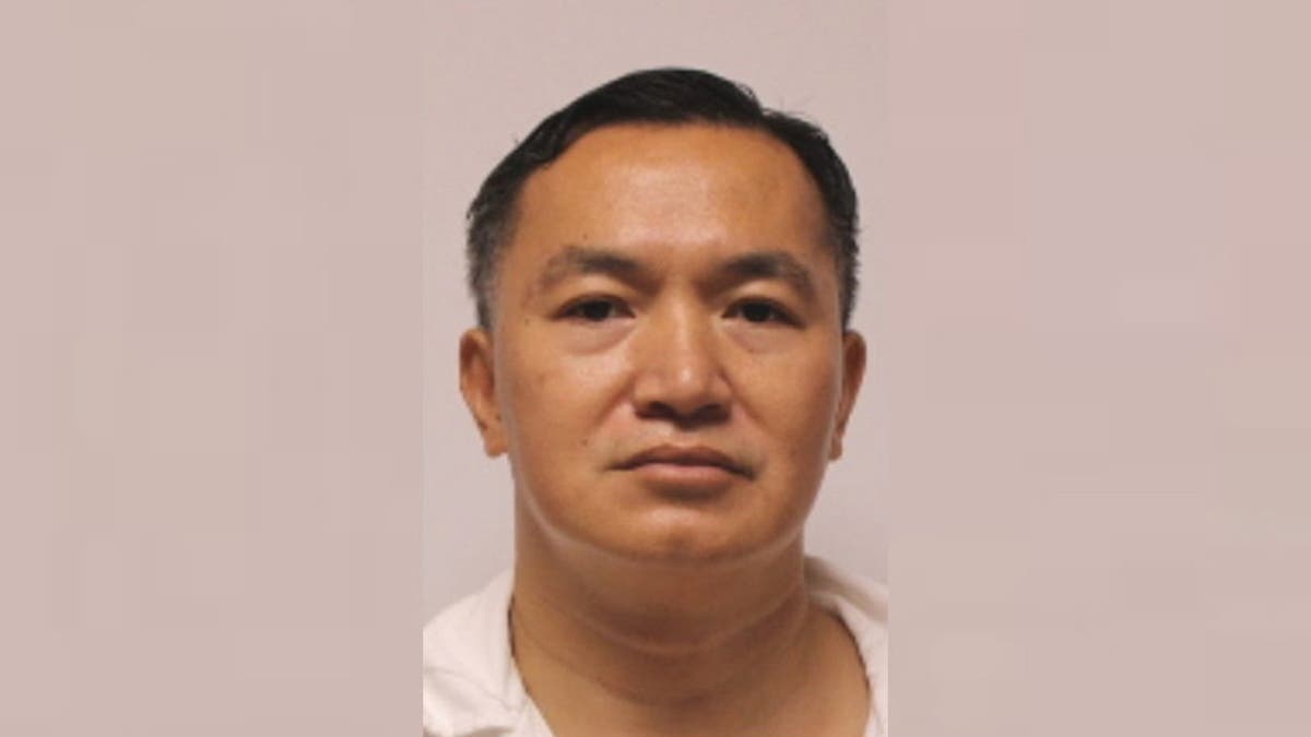 Hoang is seen successful  his mugshot photo