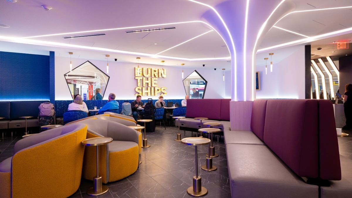 People sitting inside an airport lounge