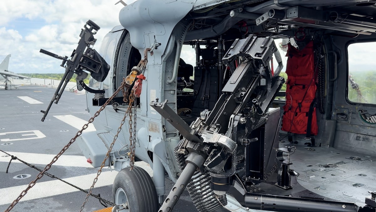 An HSC-26 helicopter sits on the flight deck of the USS Kearsarge during Sail 250 in New Orleans.