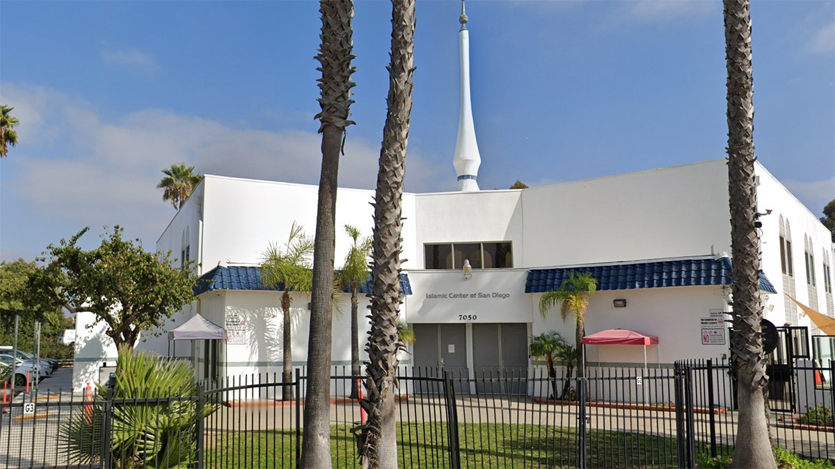 Exterior view of the Islamic Center of San Diego with palm trees and the mosque entrance visible.