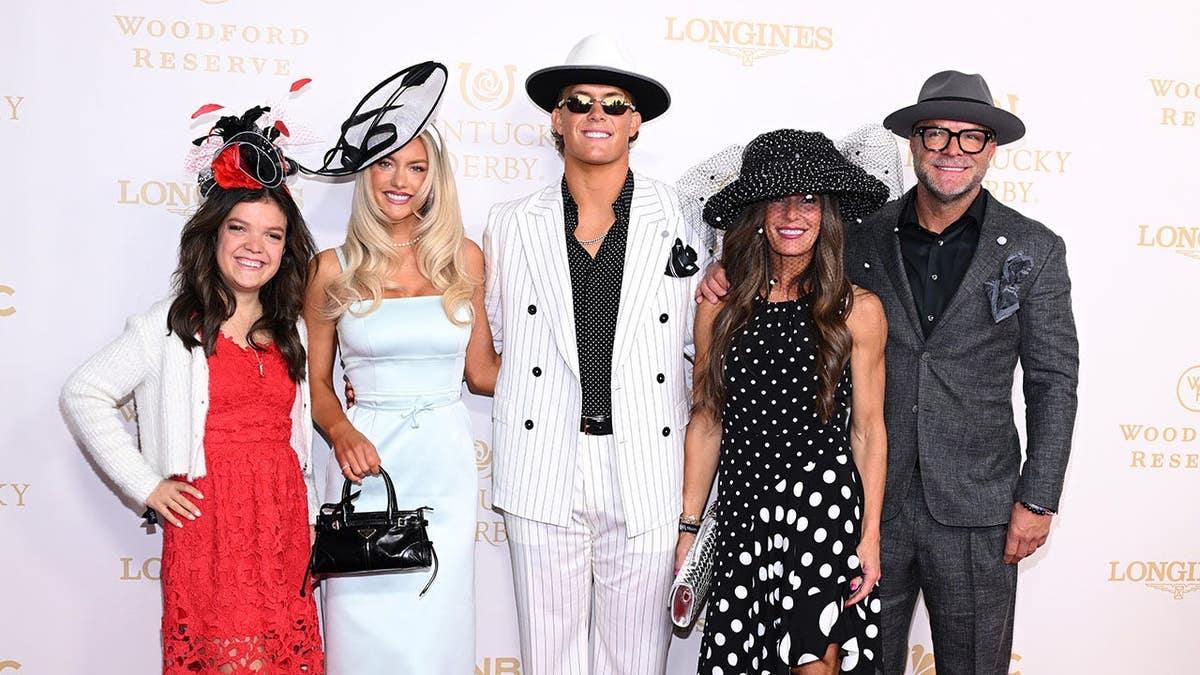 Marissa Ayers, Jaxson Dart, Kara Dart, and Brandon Dart standing at Churchill Downs