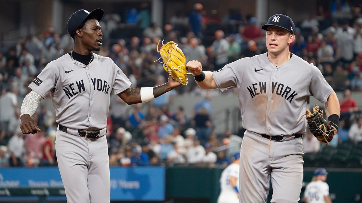 New York Yankees Jazz Chisholm Jr. and Ben Rice fist bump running off field