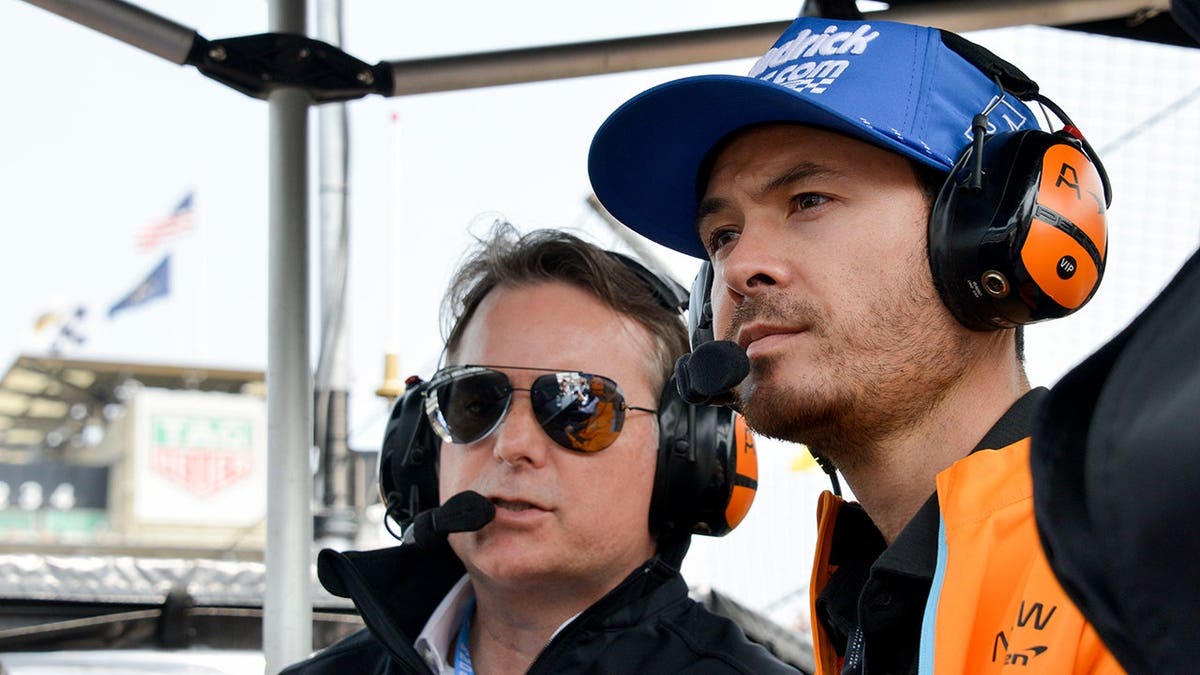 Jeff Gordon and Kyle Larson sitting successful  the Arrow McLaren pit container  astatine  Indianapolis Motor Speedway.