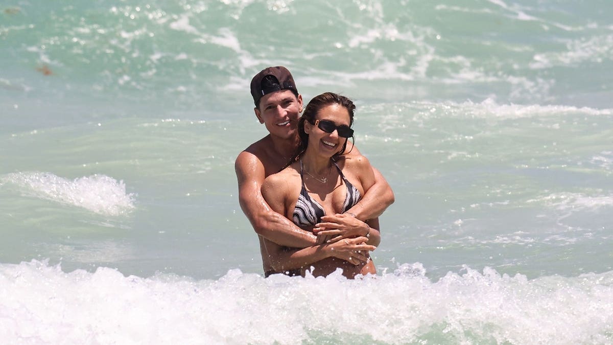 Danny Ramirez hugs Jessica Alba on the beach in Miami.